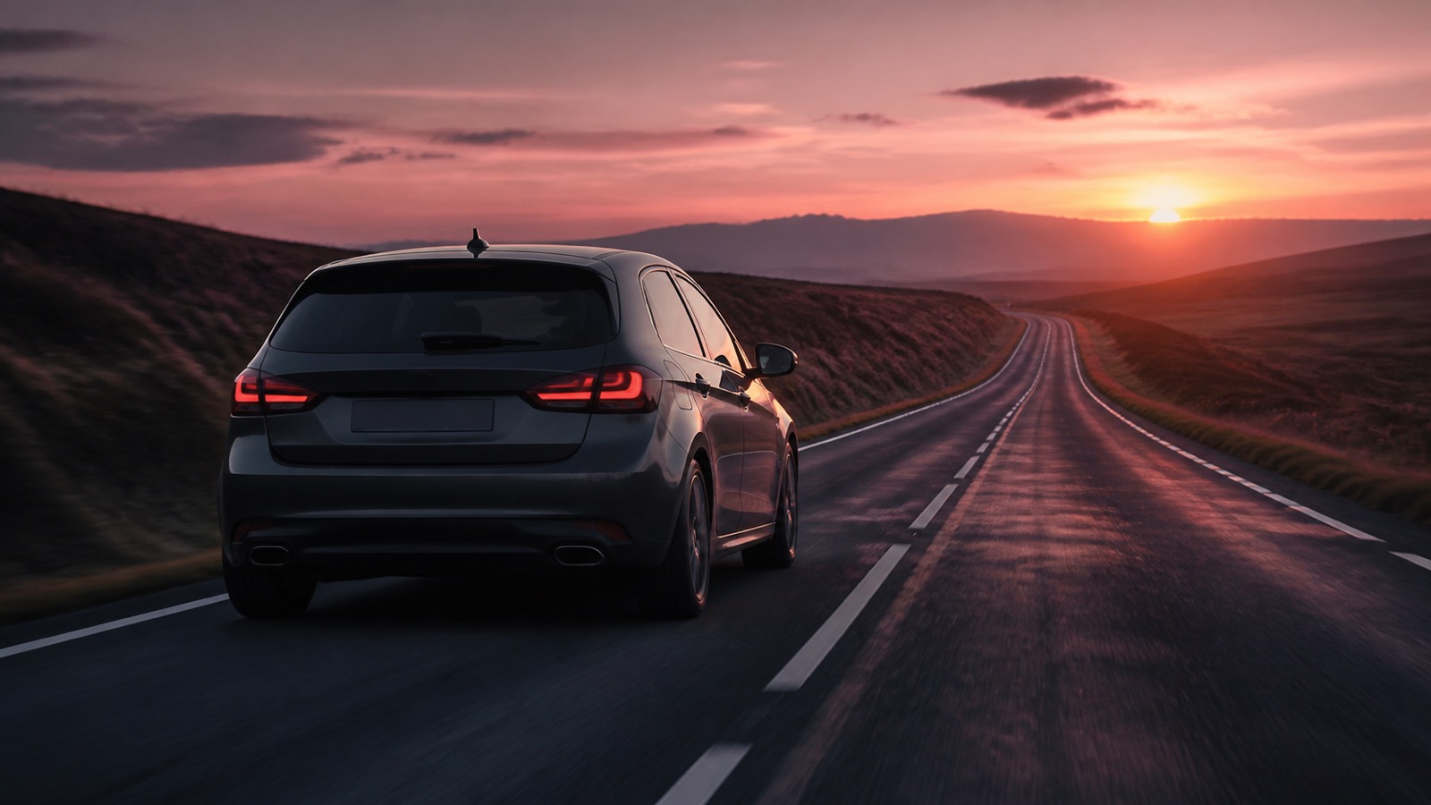 Diesel car cruising on a quiet UK A-road at dusk