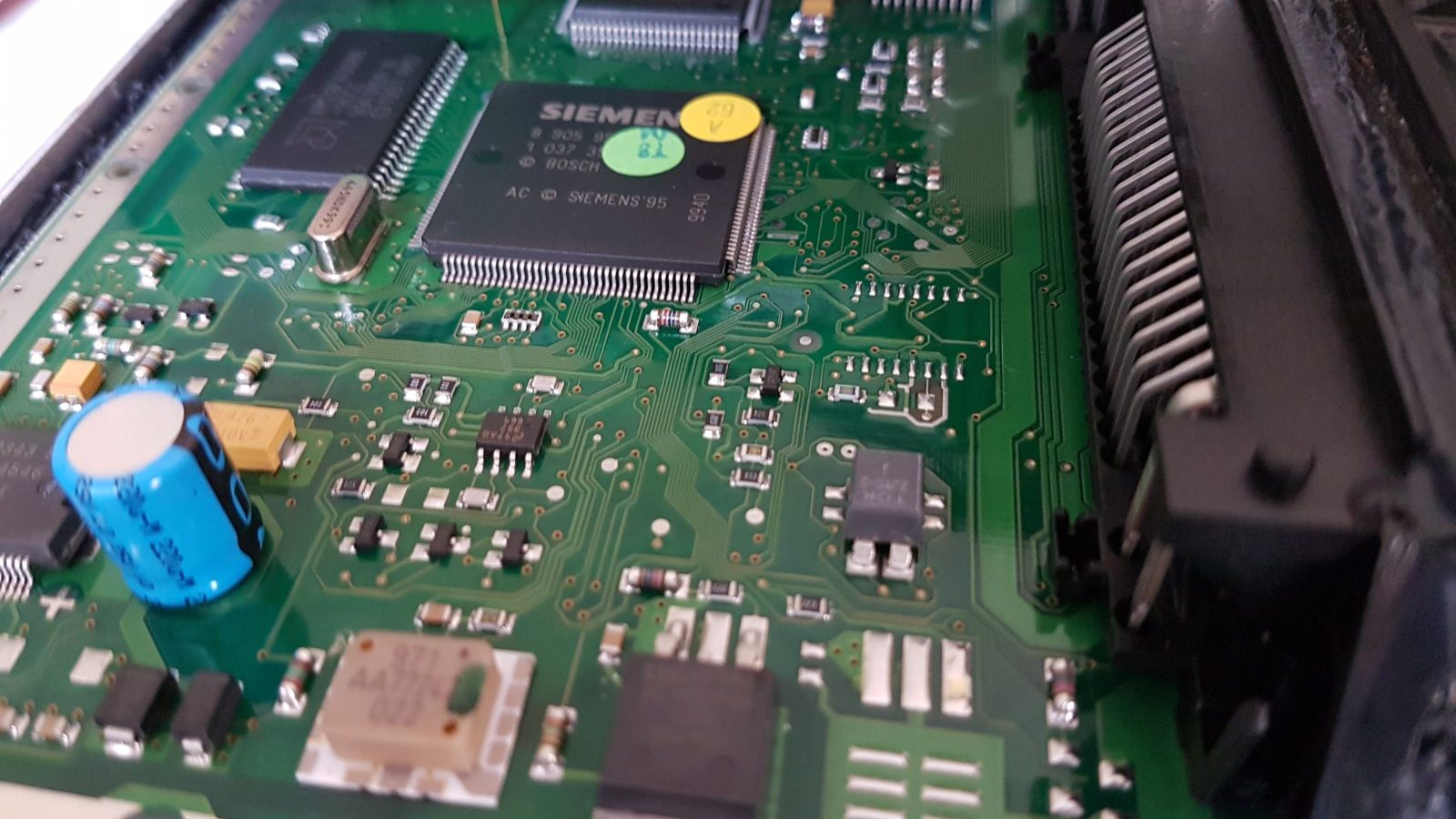 Close-up of an ECU circuit board with the case open for boot mode programming